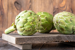 Fresh raw artichokes on vintage cutt, a Food & Drink Photo by Alexander Prokopenko