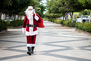 Santa Claus walking through the city with a red gift sack, a Holiday Photo by etorres69