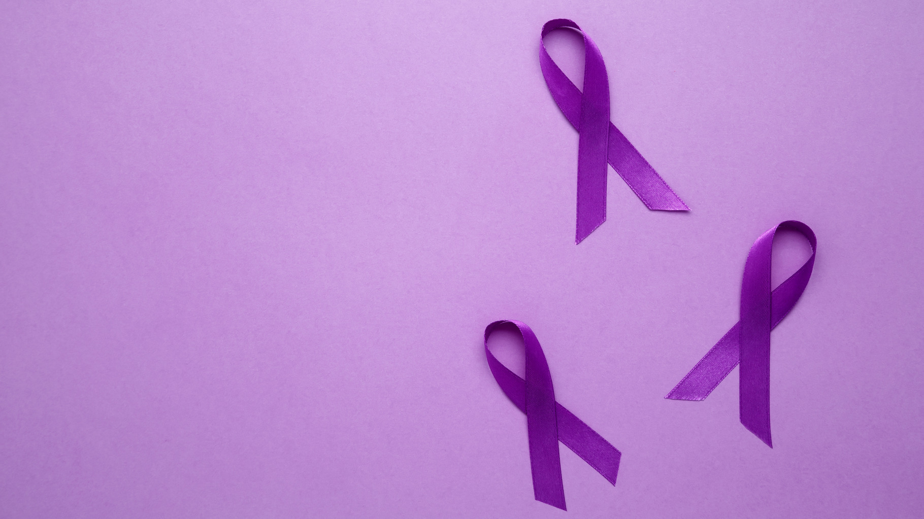 Purple ribbon held, symbol of support. Purple Epilepsy Awareness Day, a ...