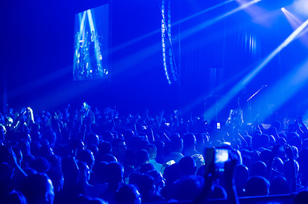Crowd at concert and blurred stage lights  containing crowd, people, and event