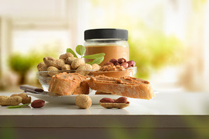 Slices of bread with peanut butter on bench in kitchen, a Food & Drink Photo by Davizro's Market