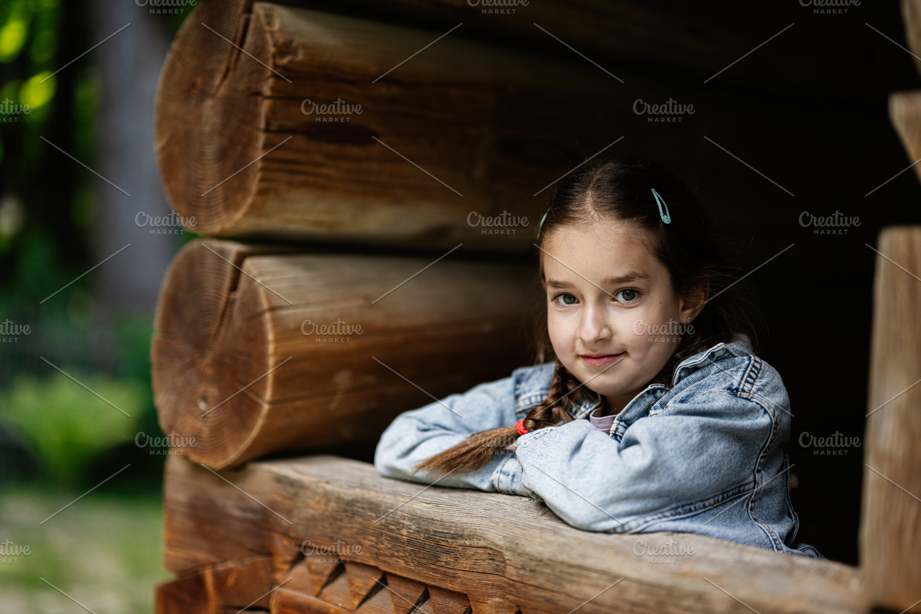Young girl smiling in a rustic wooden cabin outdoor setting, a Person Photo by AS photostudio
