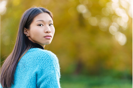 Asian woman turning to look at the, a Person Photo by Iván Moreno STOCK PHOTO