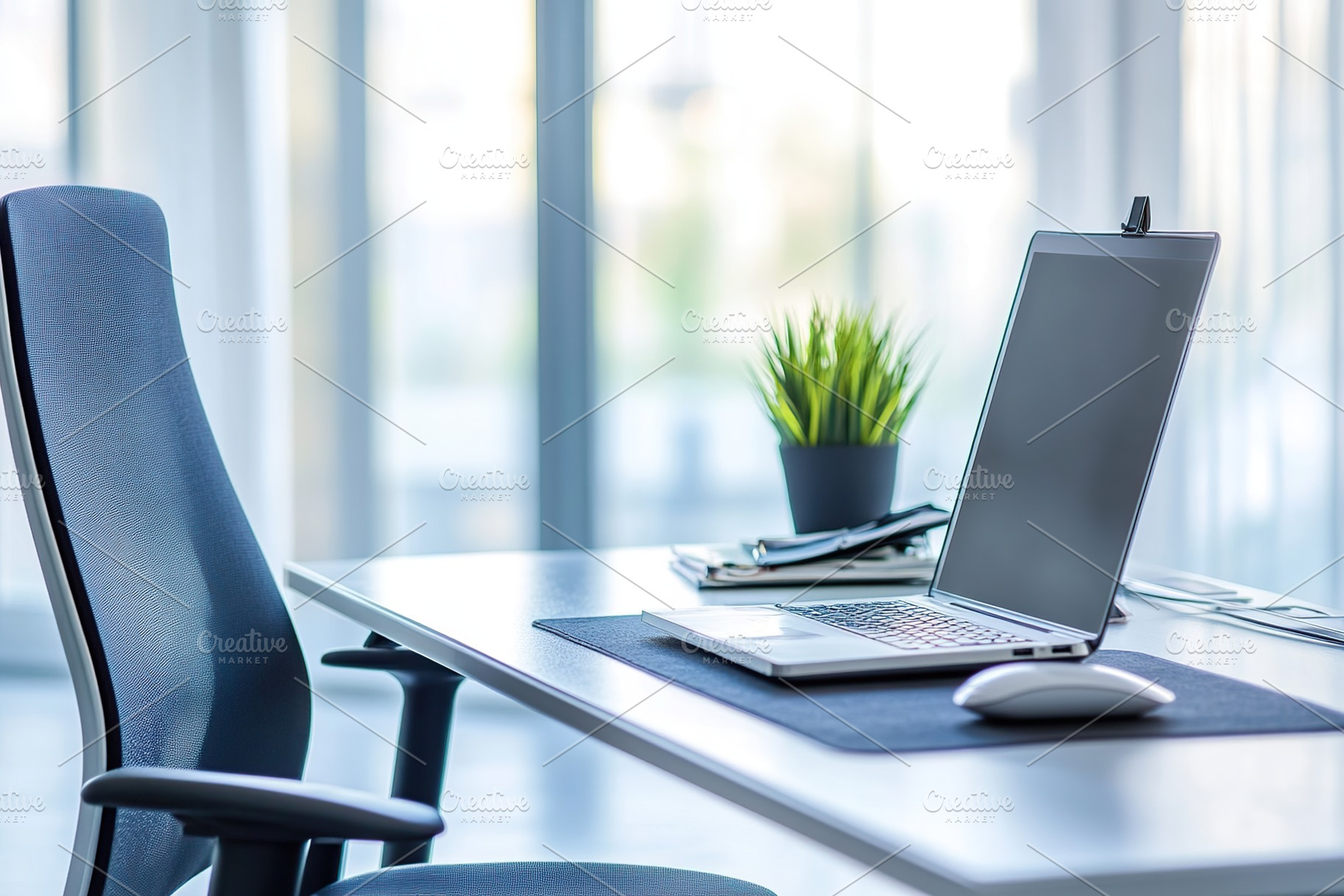 Organized modern office workspace with laptop and armchair, a Photo by AlyaAnd