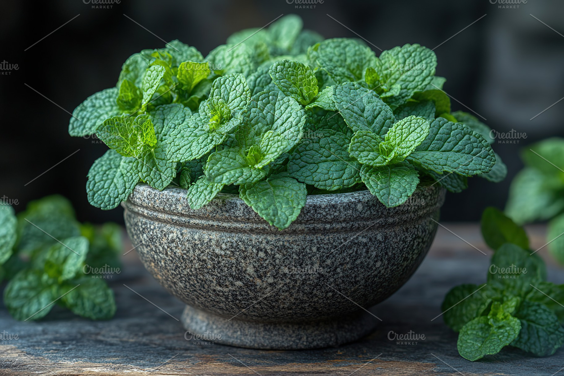 Green mint leaves in modern stone mortar on wooden table, a Food & Drink Photo by AlyaAnd