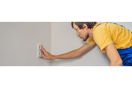 Master electrician installs a socket, an Industrial Photo by Elizaveta Galitskaya