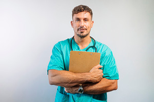 Doctor Hugging Clipboard, Looking Calm, a Person Photo by karrastock