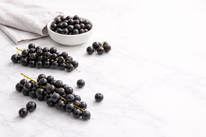 Black currant berries on white marbl, a Photo by Dvoevnore photos