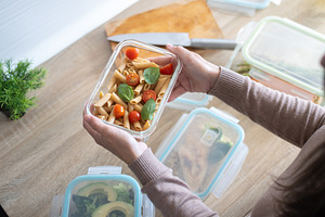 Woman holding a healthy pasta meal prep container, a Food & Drink Photo by etorres69