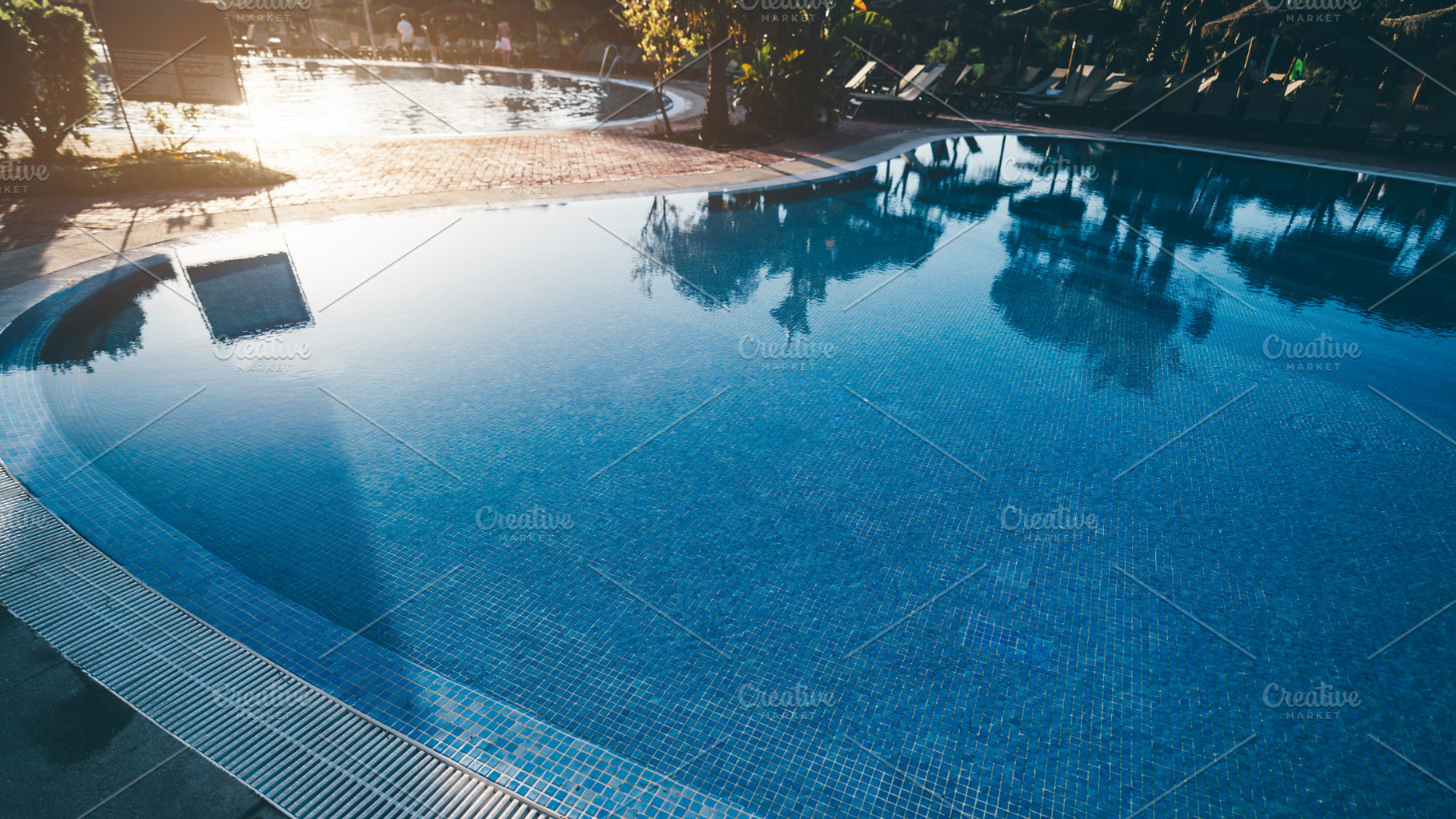 Calm resort pool with palm trees, a Sports & Recreation Photo by SkyNext