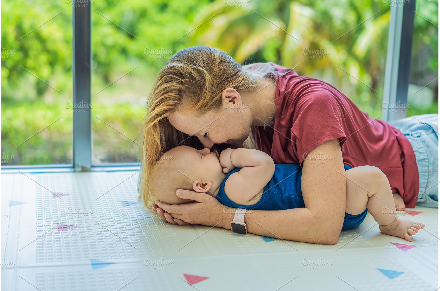 Mother and baby lying on a soft play, a Person Photo by Elizaveta Galitskaya