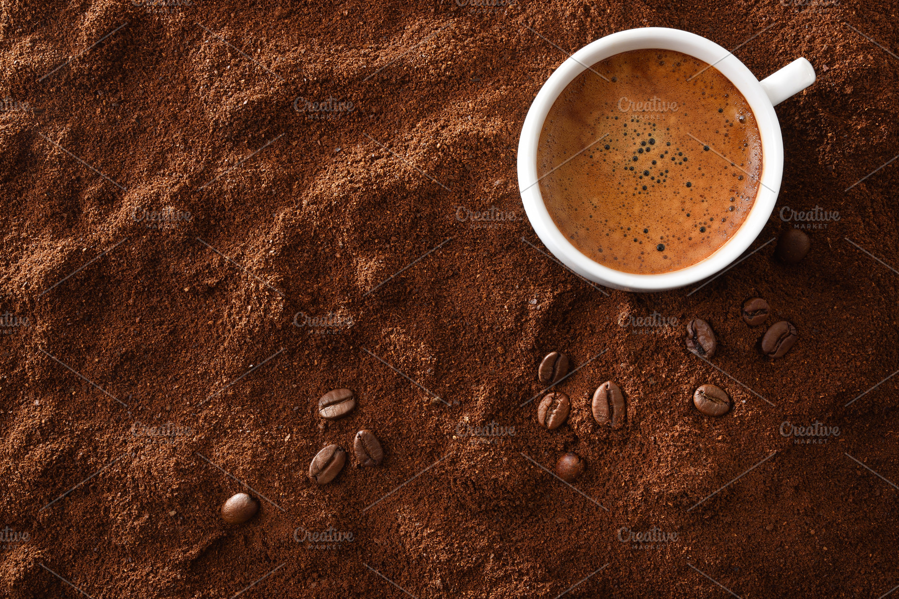 Cup of frothy coffee in corner over ground with beans, a Food & Drink Photo by Davizro's Market