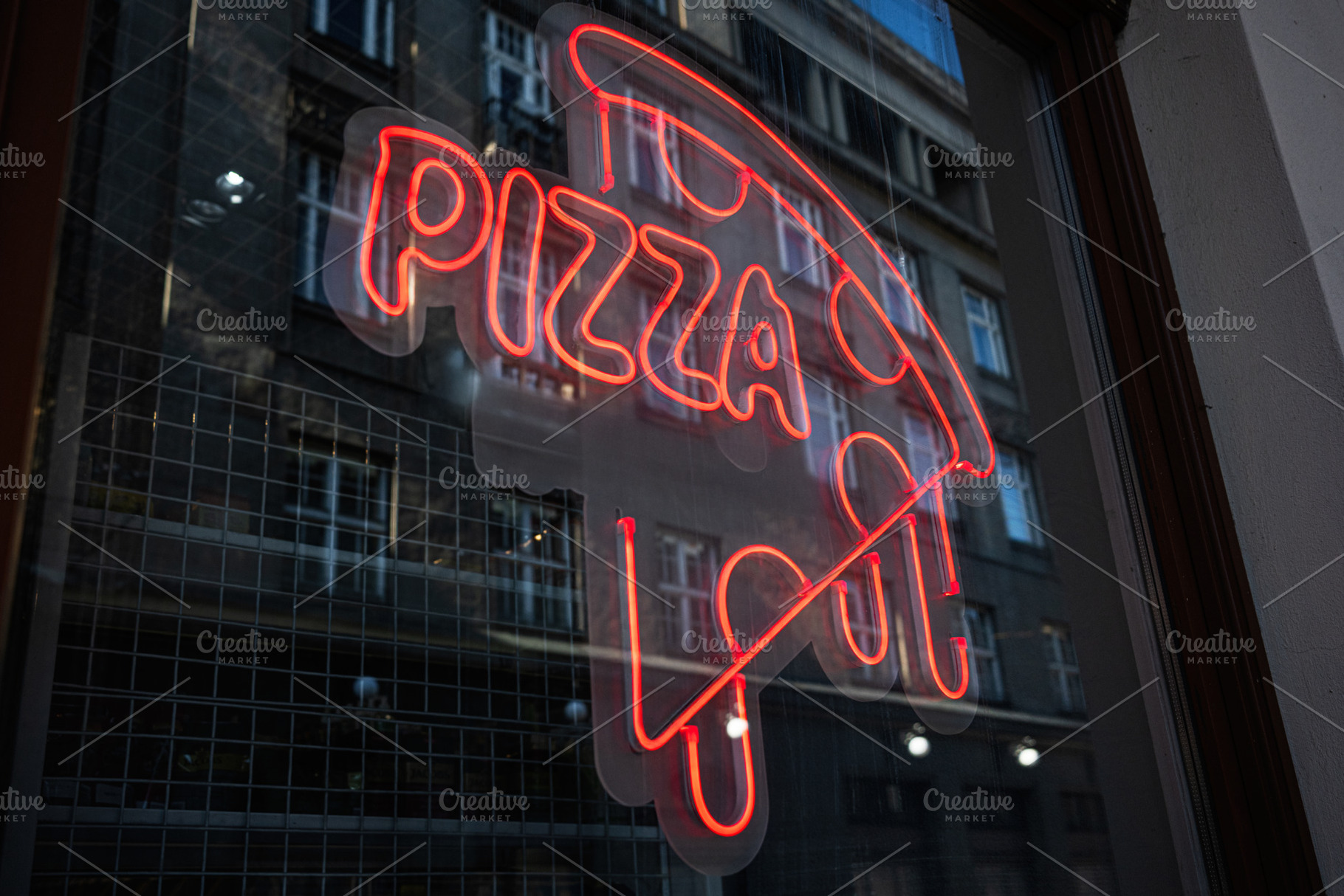 Bright neon pizza sign displayed on urban glass storefront at night, a Photo by AS photostudio