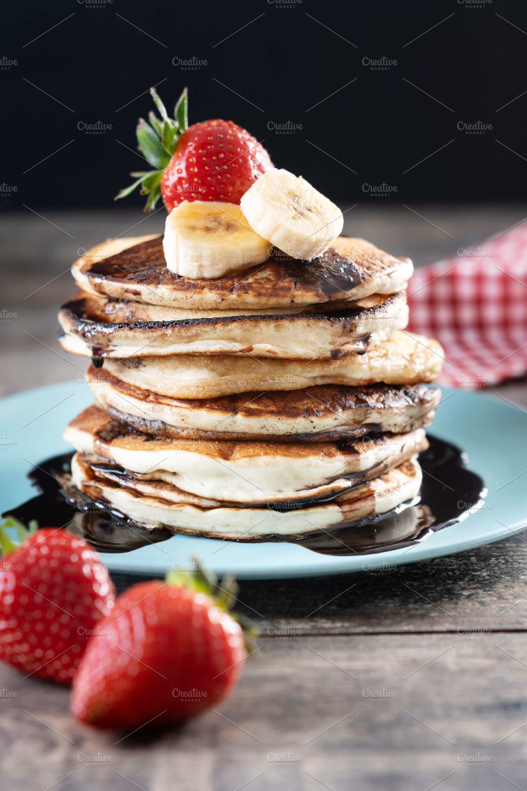 Pancakes with chocolate and fruit on wooden table, a Food & Drink Photo by etorres69