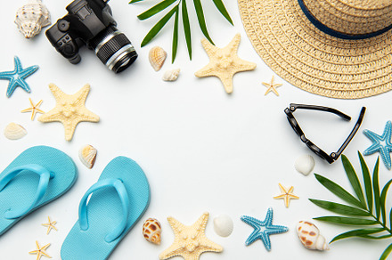 Summer accessories creating a frame on white background with cop
