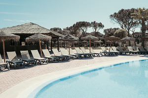 Resort pool with tiki bar, loungers, a Sports & Recreation Photo by SkyNext