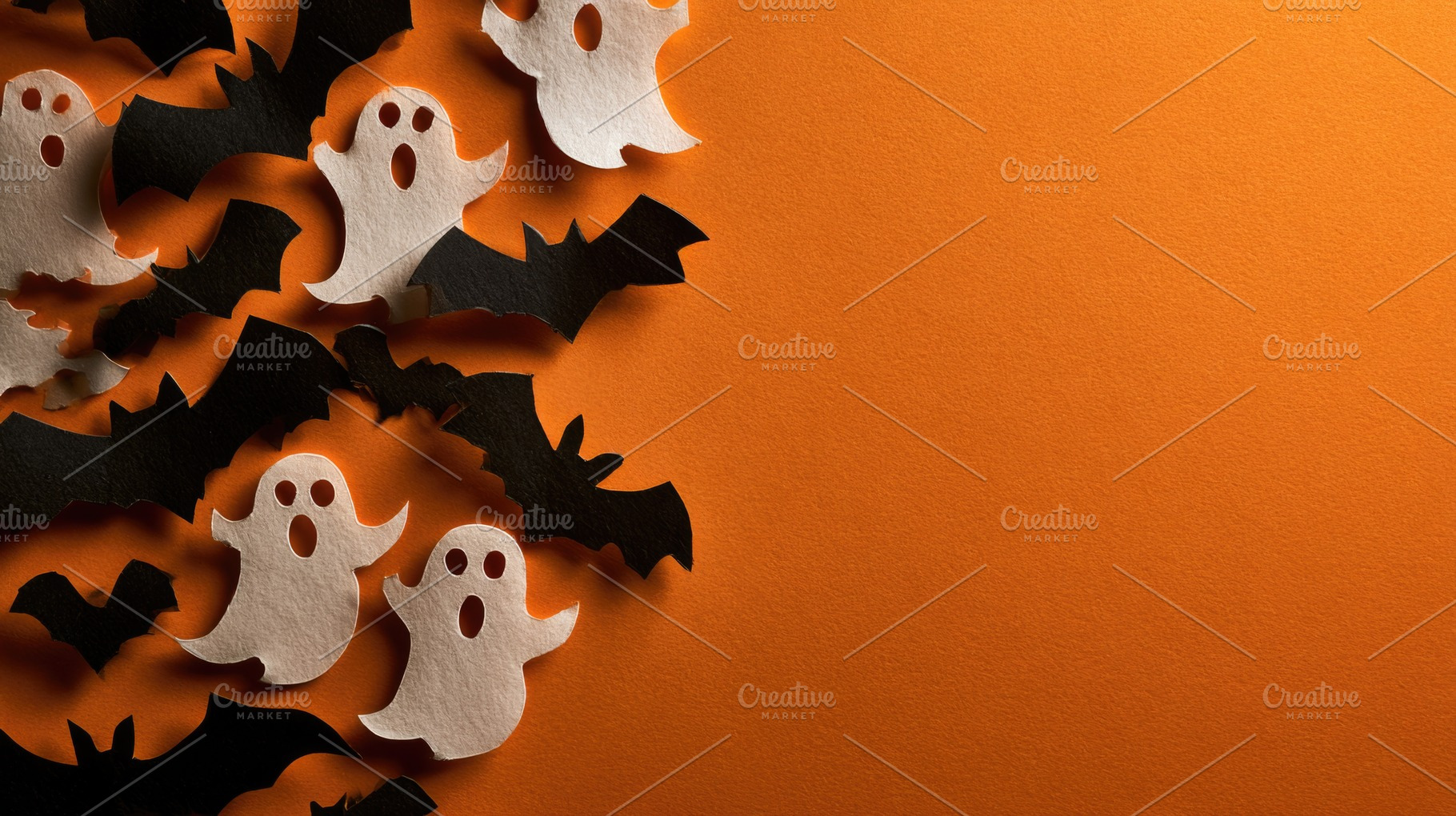 Halloween paper ghosts and bats on orange copy space, a Background Photo by José Manuel Gelpi