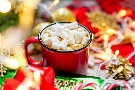 Red mug with chocolate marshmallow containing year, holiday, and new