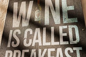 Humorous sign about wine and meals in a rustic setting, a Photo by AS photostudio