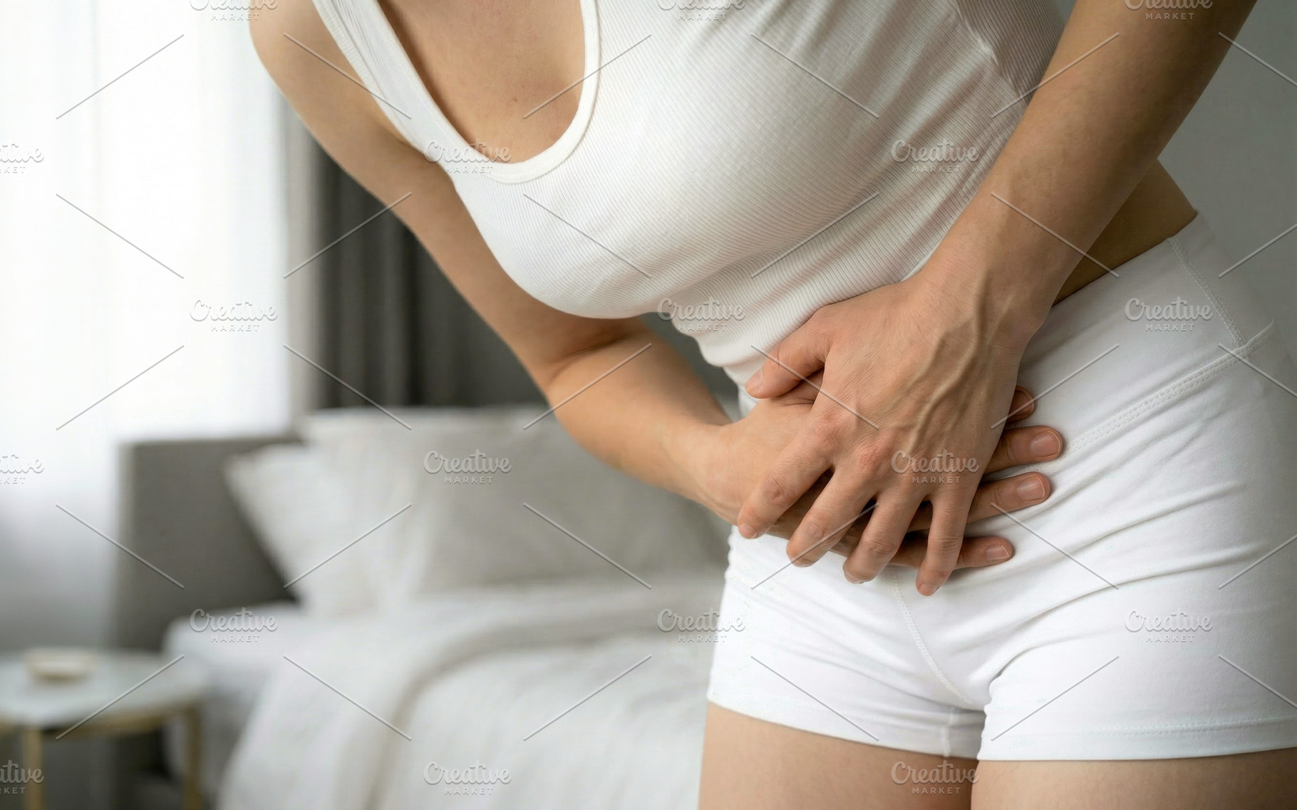 Woman Holding Lower Abdomen Pain While Standing, a Person Photo by Davizro's Market