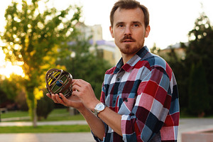 Young man holding antique globe, a Person Photo by Elena Vagengeim