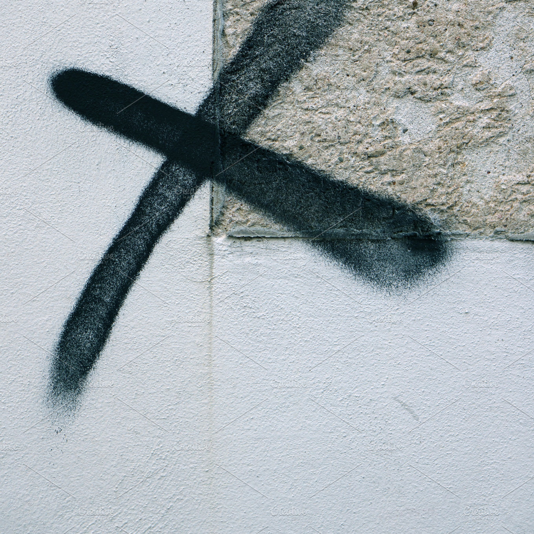 X containing concrete, wall, and grafitto