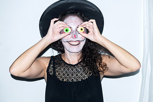 Woman in witch hat posing with Halloween eyeballs, a Person Photo by etorres69