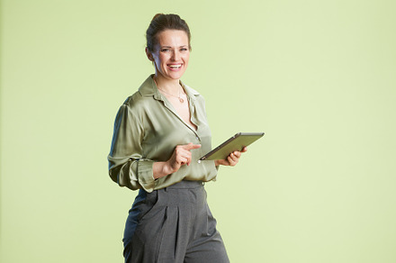 Confident woman pointing at tablet, a Business Photo by Alliance Images