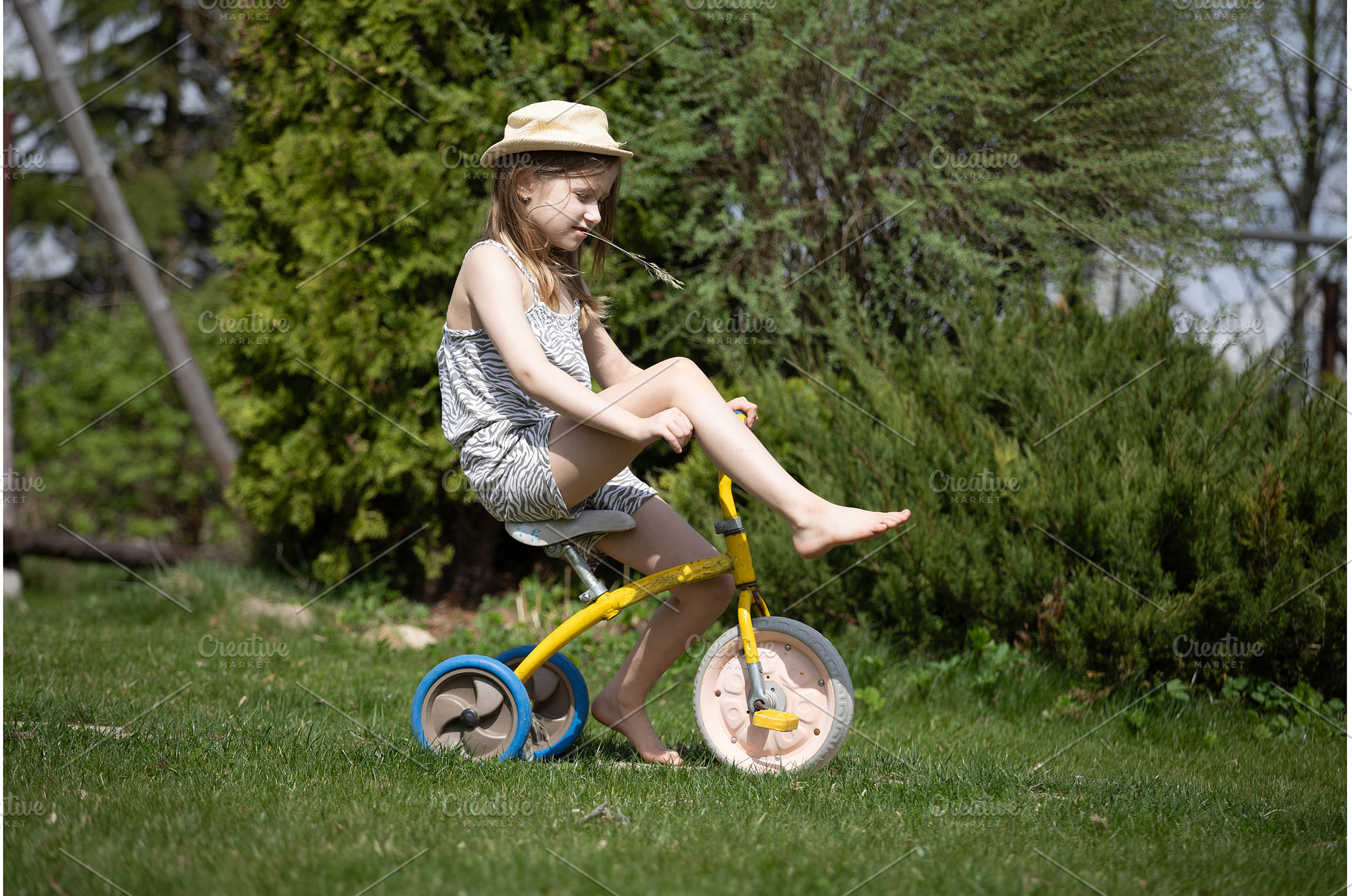 A girl on a small bicycle is resting, a Nature Photo by Nenahliadava Design