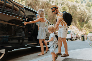 Parents with toddlers boarding car, a Transportation Photo by HalfPoint
