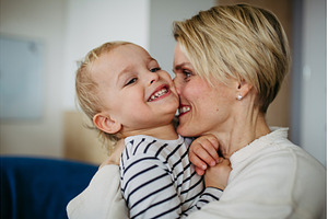 Beautiful mother hugging and kissing, a Person Photo by HalfPoint