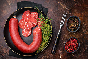 Sliced and whole Turkish sucuk (sujuk) in a cast iron pan with t, a Photo by composter-box@mail.ru