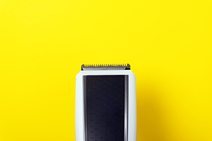 Top view of a black and white electric hair clipper on a bright, a Technology Photo by Ales Munt