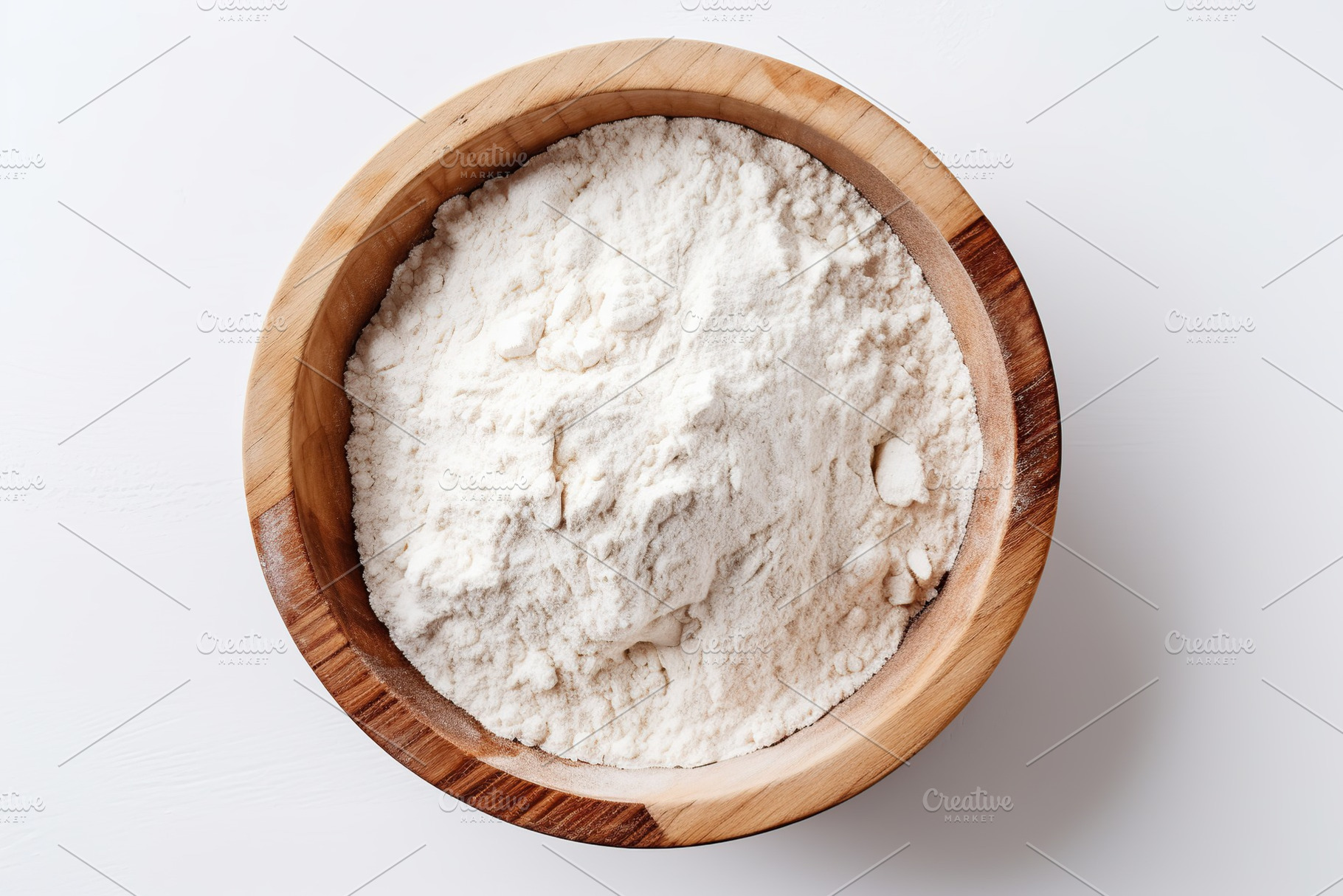 Flour in wooden bowl on white background, a Food & Drink Photo by AlyaAnd