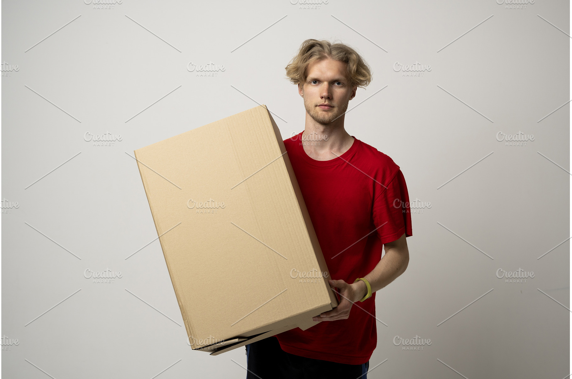 Young delivery man holding a big, a Person Photo by volodymyrshtun13795