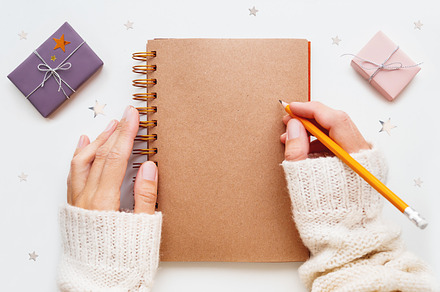 Woman is preparing to write or draw containing christmas, new year, and goal
