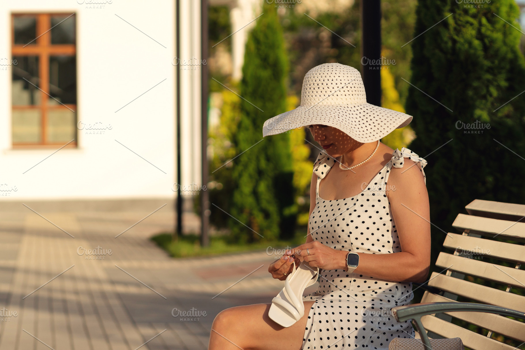 Woman in polka dot dress sitting on, a Beauty & Fashion Photo by Elena Vagengeim