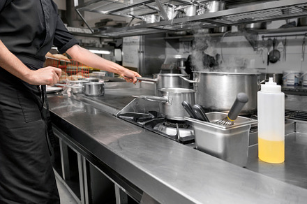 Unrecognizable Chef cooking in modern industrial kitchen., a Person Photo by david.herraez.calzad