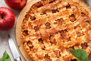 Freshly baked apple pie decorated with cinnamon sticks and apple, a Food & Drink Photo by Olena Rudo