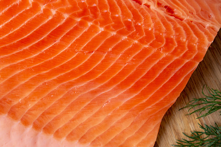 Organic Raw Salmon Fillet on a wooden board, top view. Flat lay,, a Food & Drink Photo by LiudmylaChuhunova