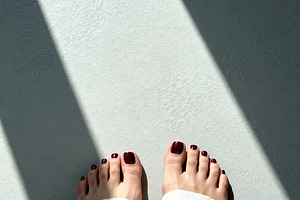 Minimalist Feet with Red Pedicure, a Beauty & Fashion Photo by Virgo Studio