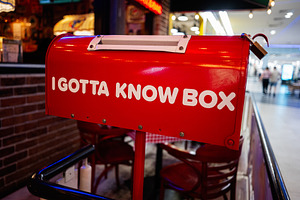 Red mailbox with I gotta know box text, mall environment, a Photo by AS photostudio