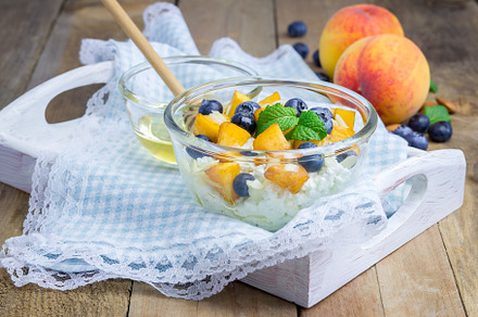 Fresh cottage cheese with peach, blueberry, almonds and honey. Concept of healt, a Food & Drink Photo by iuliia_n