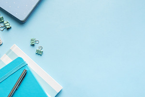 Office workspace with keyboard, notebooks, and blue supplies, a School & Education Photo by Olena Rudo