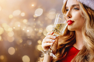 Portrait of woman drinking sparkling wine with background golden, a Holiday Photo by Davizro's Market