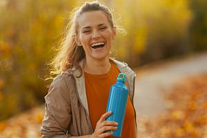 smiling fit 40 years old woman in fitness clothes in park, a Person Photo by Alliance Images