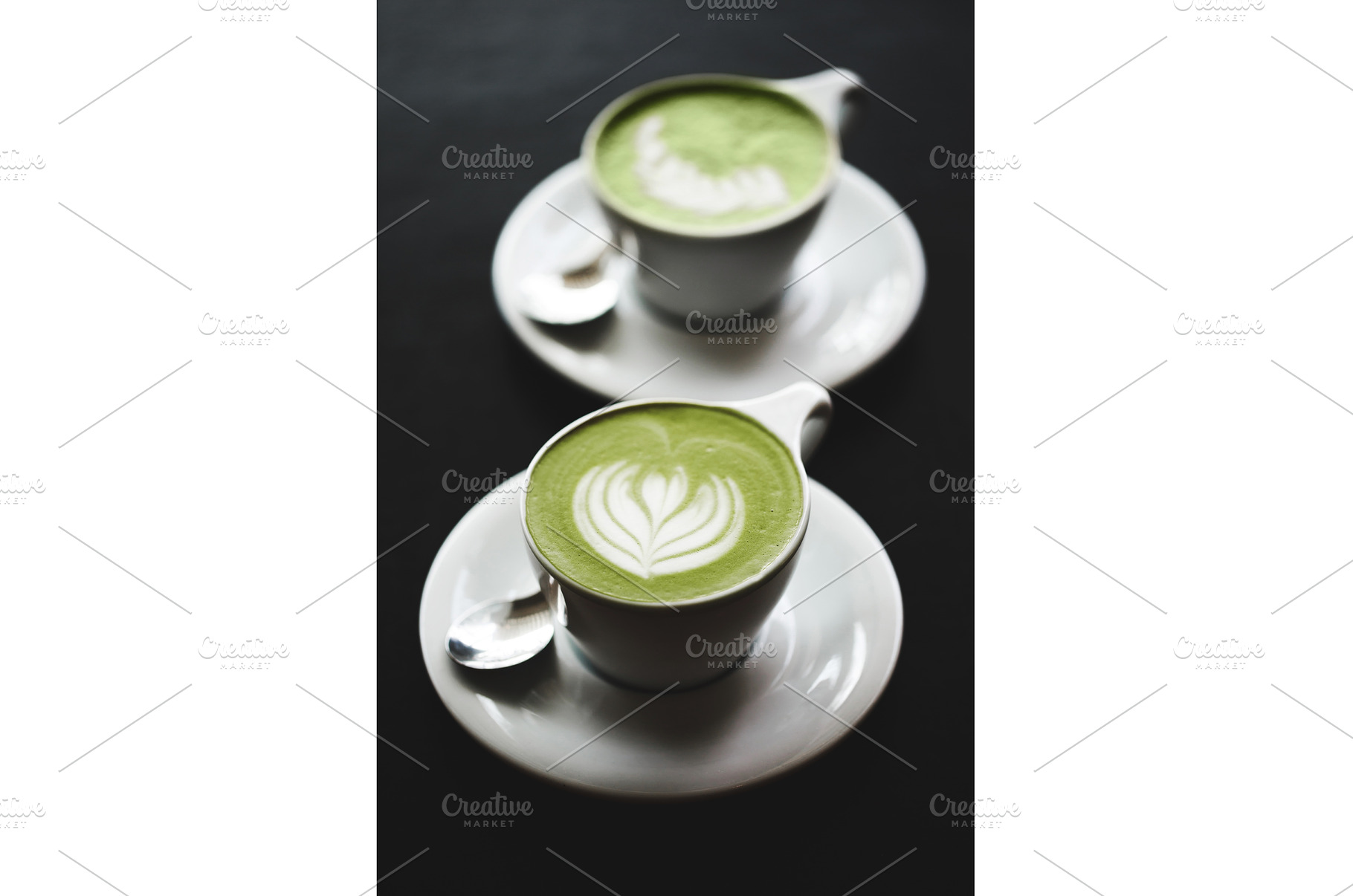 Two cups of matcha latte on black, a Food & Drink Photo by Anna Efetova