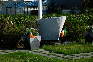 Outdoor memorial with Irish flags in Akranes, Iceland on a sunny day, a Photo by AS photostudio