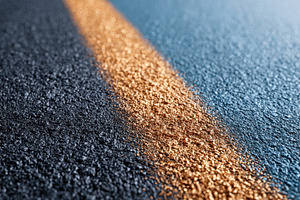Golden lane marking on textured asphalt, an Abstract Photo by AlyaAnd