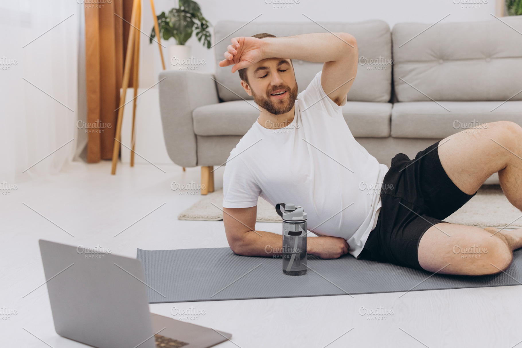 Handsome adult man using laptop and drinking water while having, a Sports & Recreation Photo by Cherkas Photography